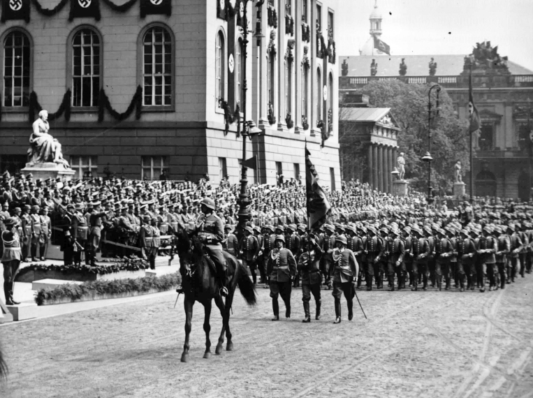 Adolf Hitler salutes the parade for his birthday